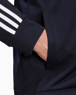 ADIDAS - GIACCA DA ALLENAMENTO PRIMEGREEN ESSENTIALS WARM-UP 3-STRIPES - H46100