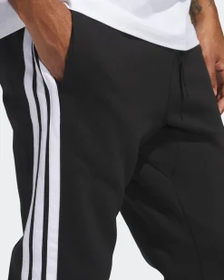 ADIDAS - PANTALONI TUTA DA UOMO NERI  ESSENTIALS 3 - STRIPES FELPATI  -JD1861