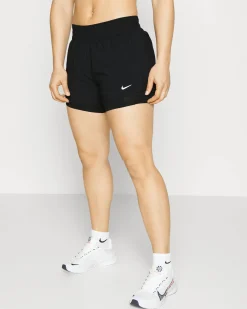 NIKE - Pantaloni corti loose fit da donna neri in tessuto traspirante con logo bianco